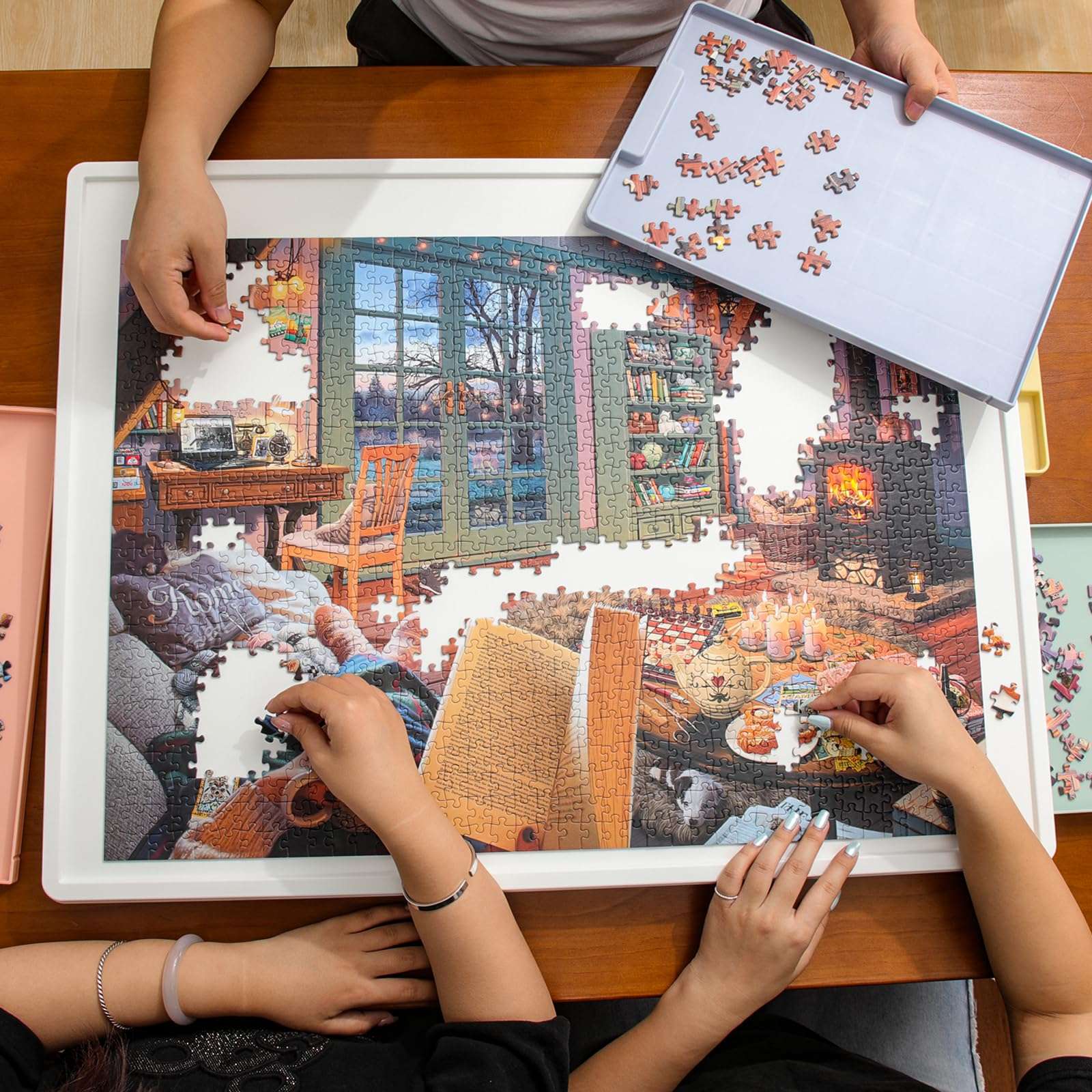 family working together on white puzzle board with rotating tray and drawers